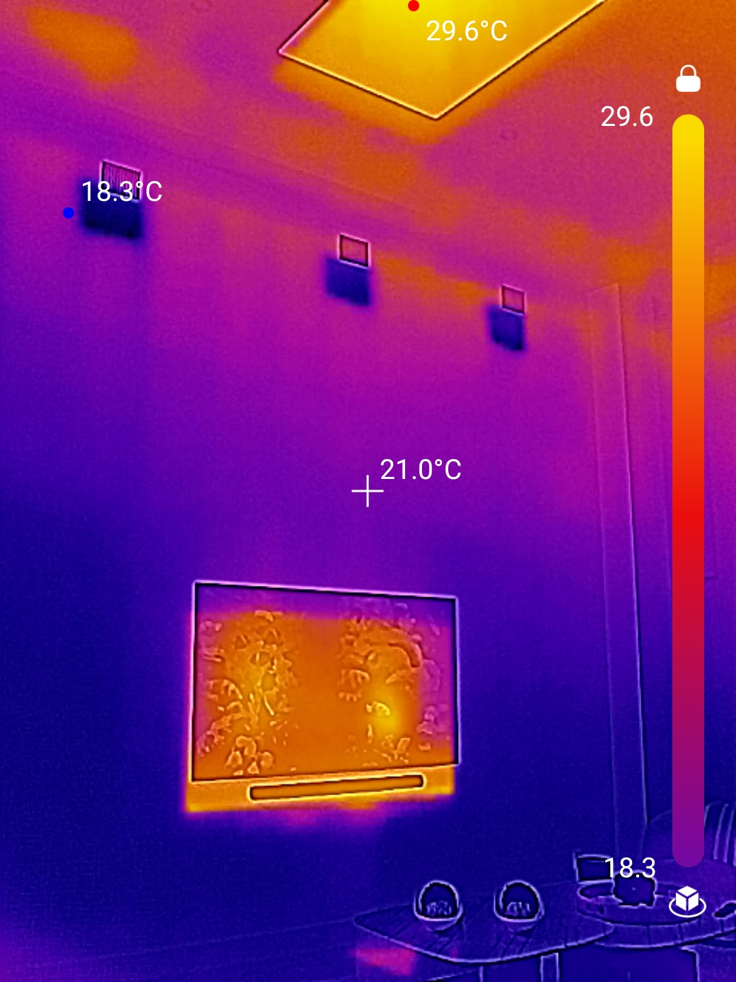 Thermal imaging camera showing temperature differentials on wall indicating moisture intrusion